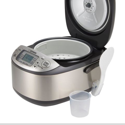 Accessories include steaming basket, rice measuring cup, nonstick rice spatula and spatula holder