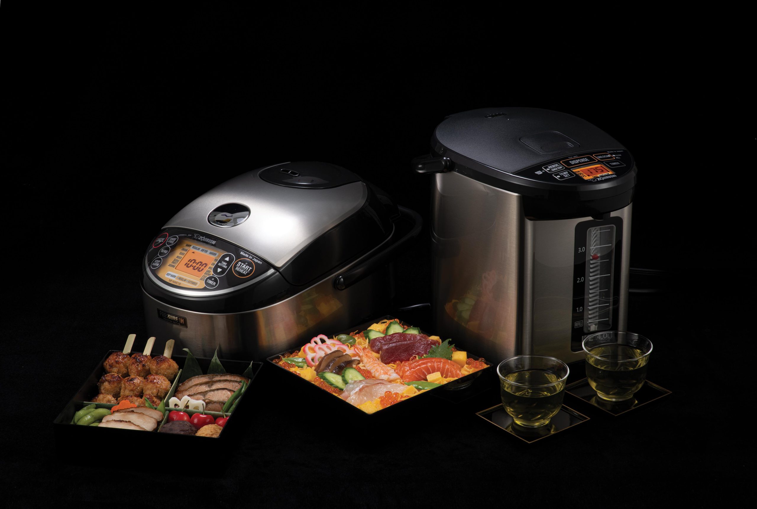 VE Hybrid Water Boiler and Warmer with matching Pressure IH Rice Cooker and Warmer NP-NWC10/18 with a brewed green tea and a delicious bento with chirashi sushi and other japanese side dishes.