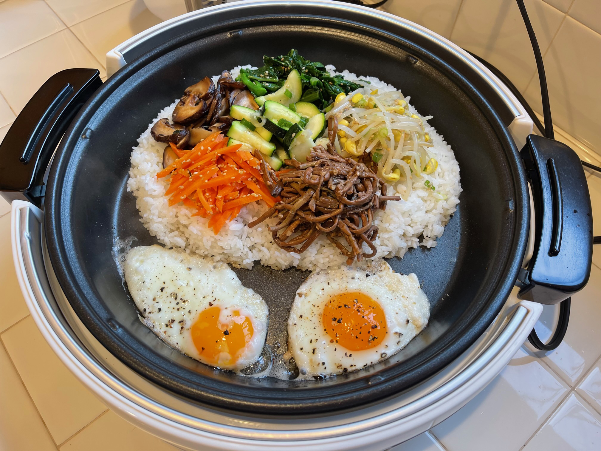 https://www.zojirushi.com/blog/wp-content/uploads/2023/03/bilbimbap-cooking.jpg