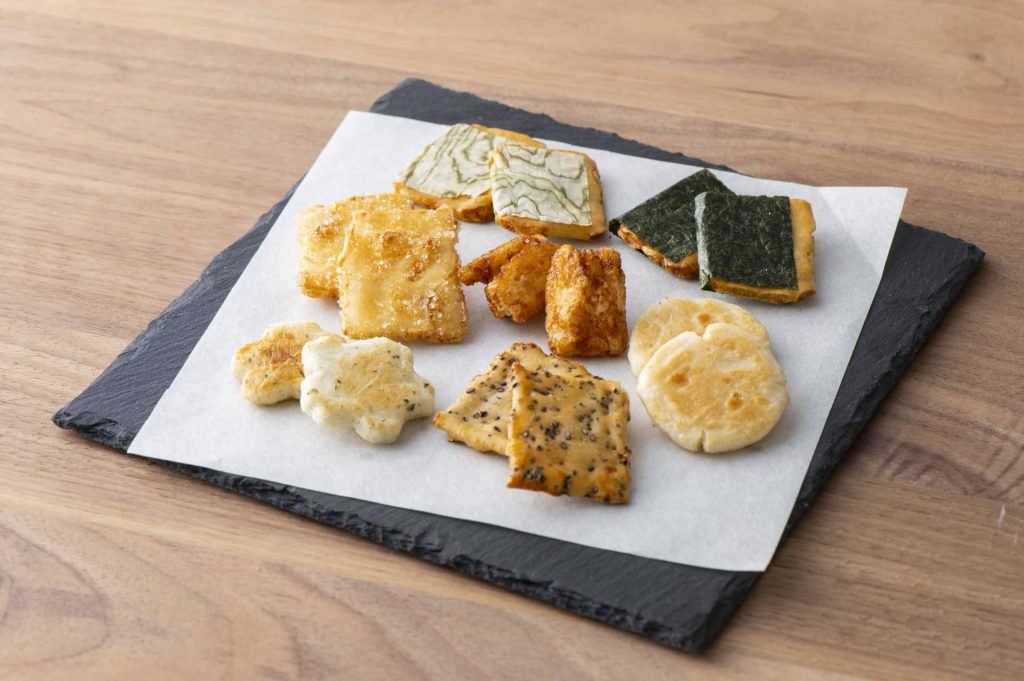 Square plate surface with an assortment of rice crackers