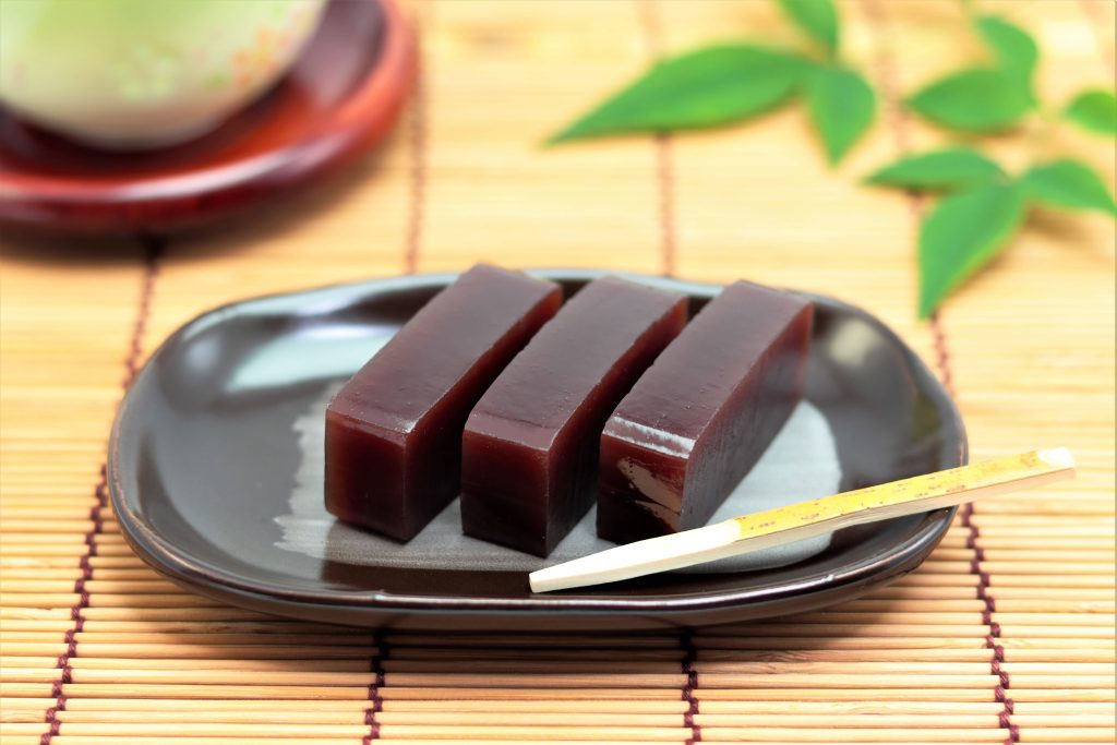 A plate with red bean yokan served with green tea