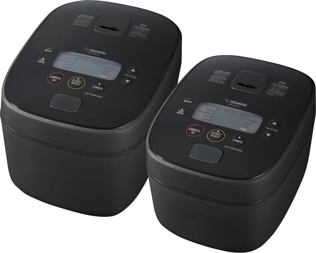 Two flat top rice cookers side by side in two different sizes. The large one is on the left and the smaller on the right