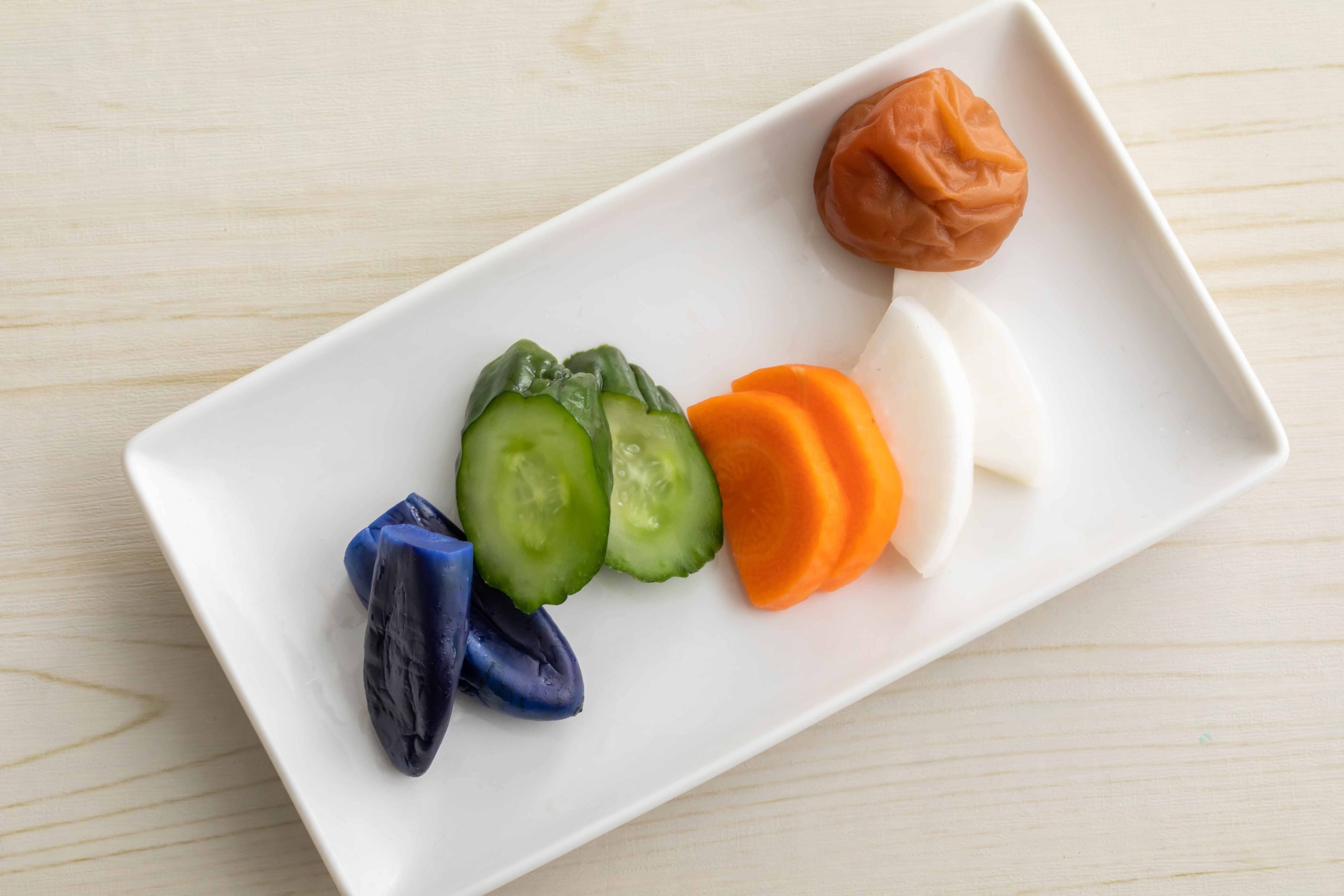 White rectangular plate with a variety of Japanese pickles
