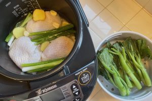 Hainan Chicken Rice shown in rice cooker before cooking
