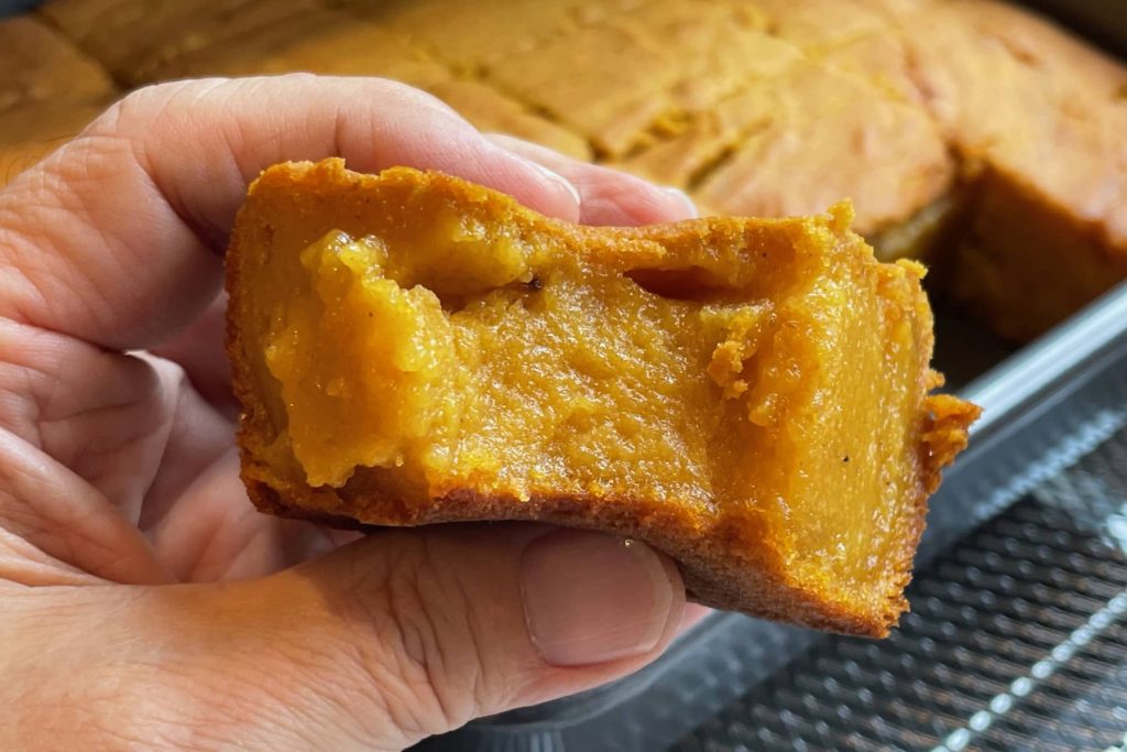 Close-up of pumpkin mochi cake showing inside texture after a bite taken out