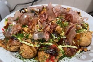 Takoyaki plated with condiments added