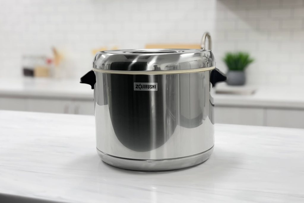 Stainless steel color warmer on a counter in a white kitchen