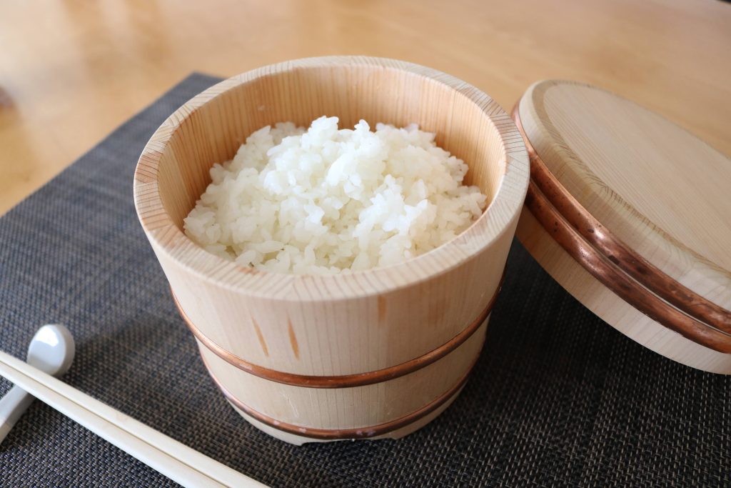 Rice in a wooden container with lid called ohitsu