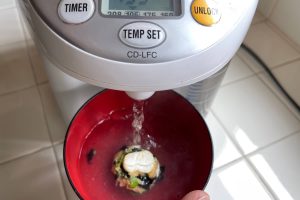 water boiler pouring water into bowl