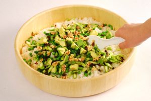 Green vegetable on sushi rice in a sushi oke
