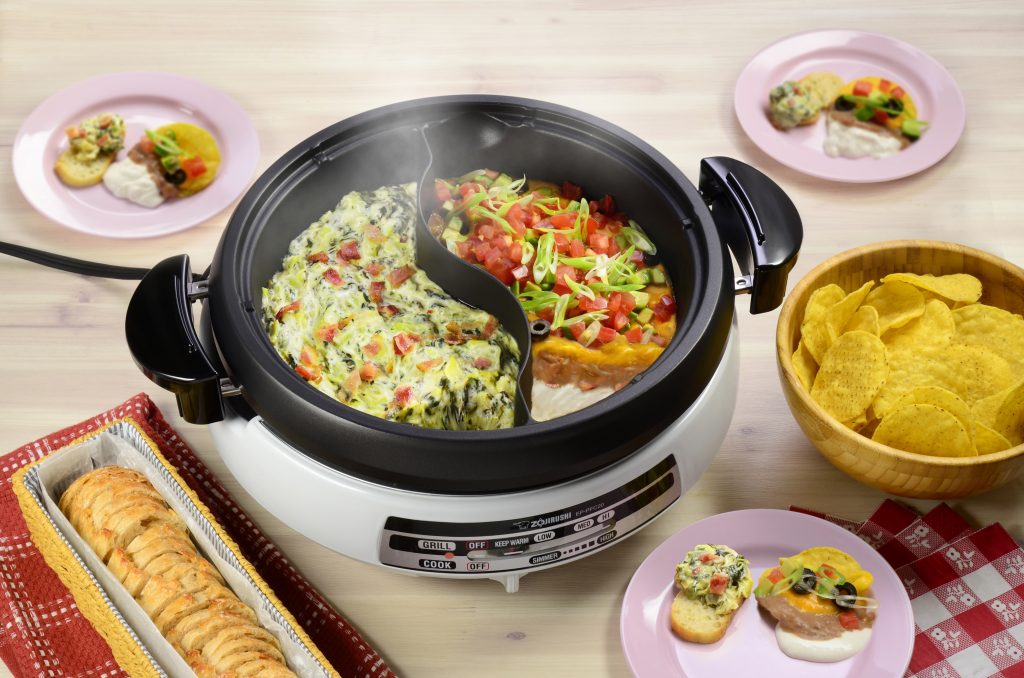 Dip duo in the yinyang hot pot on the table surrounded by other ingredients