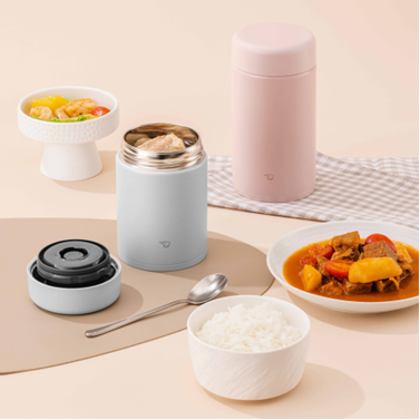 blue and pink food jar next to 3 dishes on the table