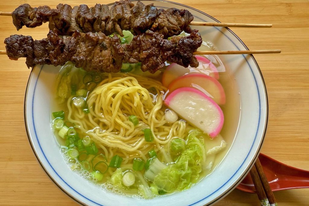 teriyaki sticks and bowl of saimin noodles