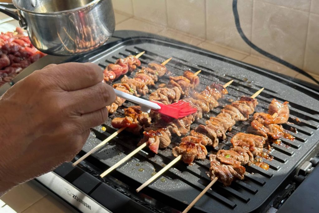 basting teriyaki sticks with sauce