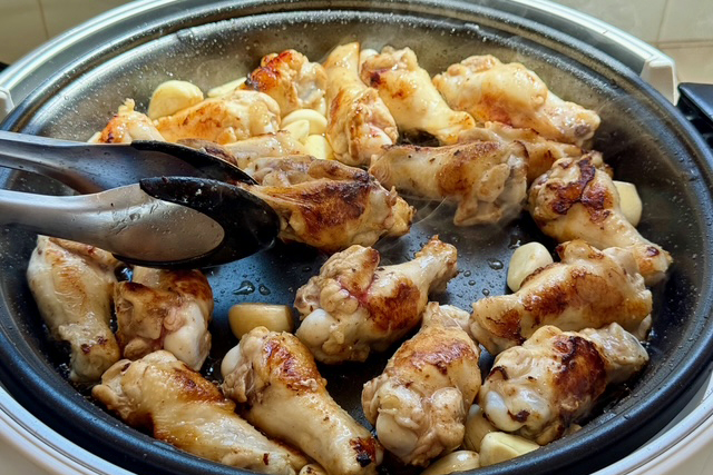 chicken drumettes frying and searing