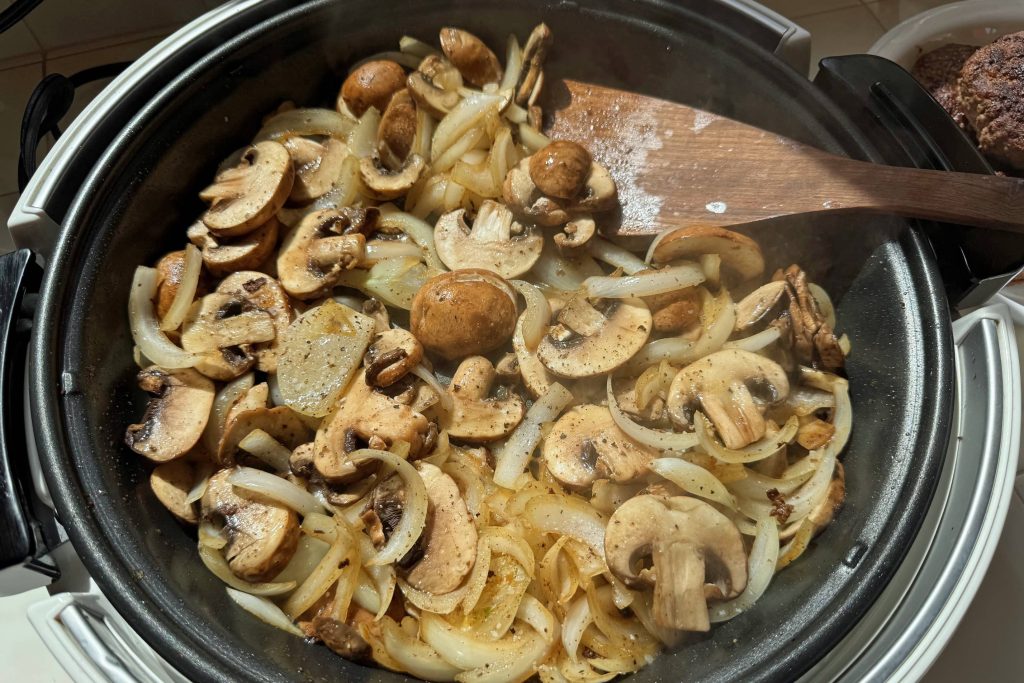 frying the onions and mushrooms for gravy
