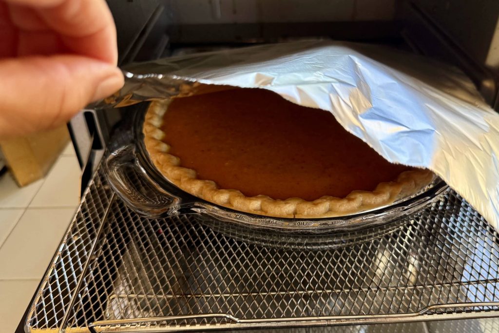 covering pumpkin pie with foil