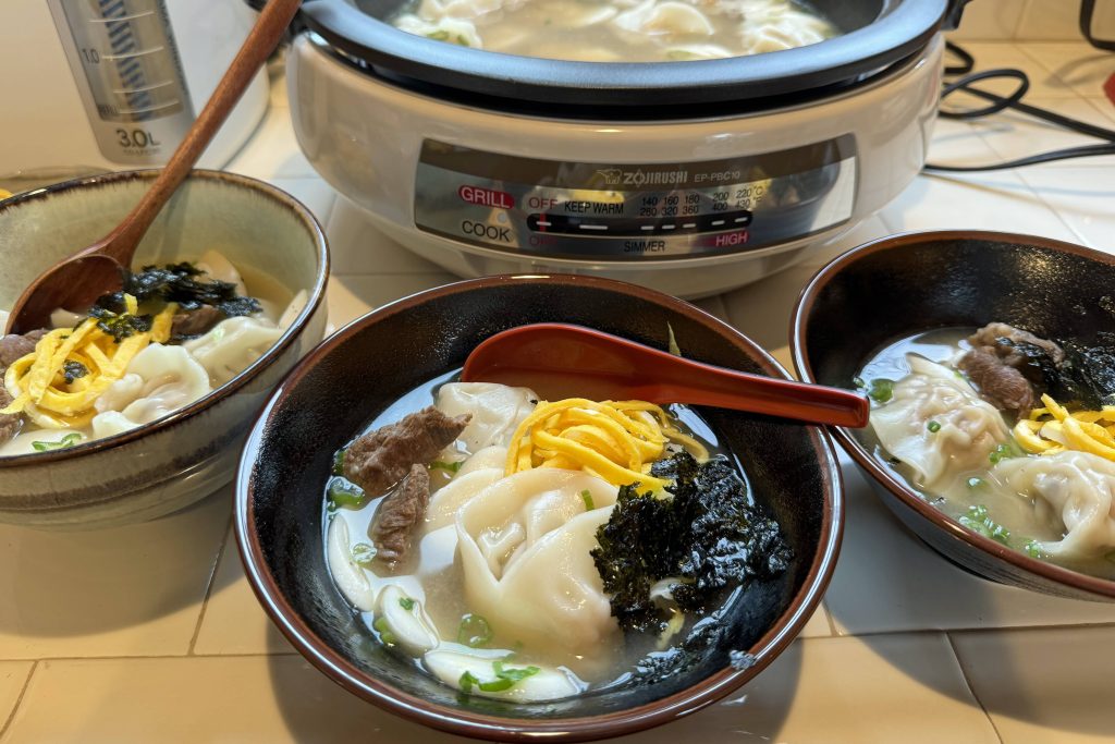 3 servings of Korean dumpling soup with garnishes