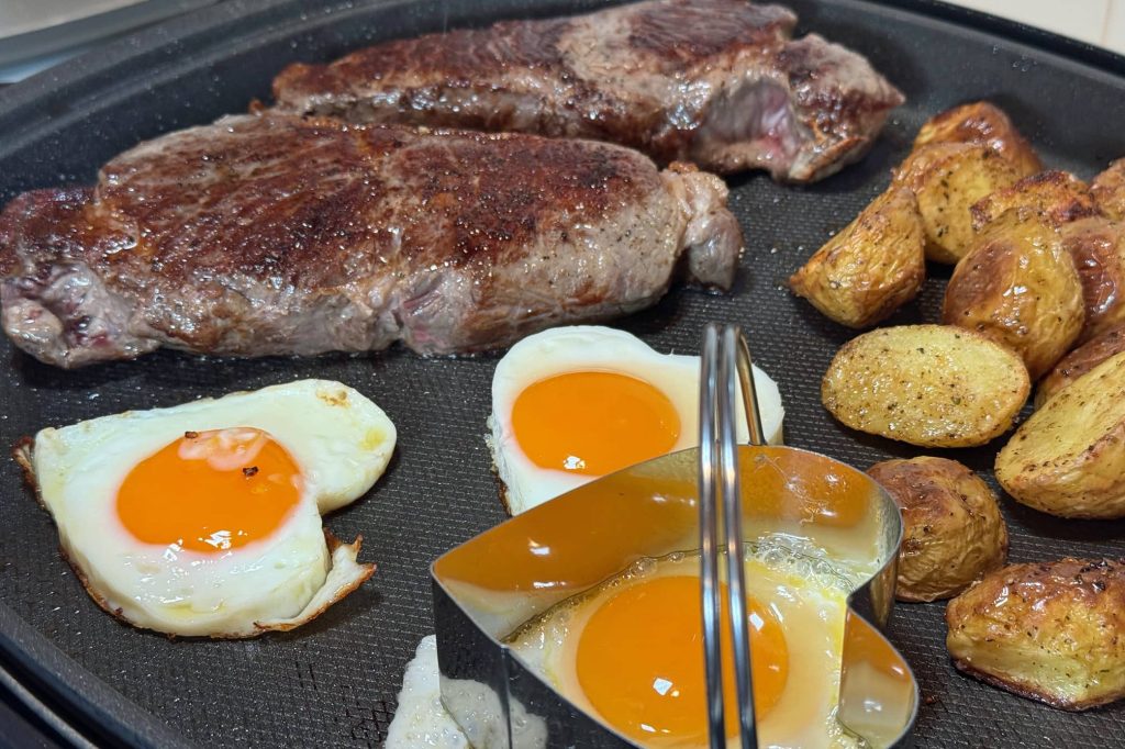 steak, heart shaped eggs and potatoes