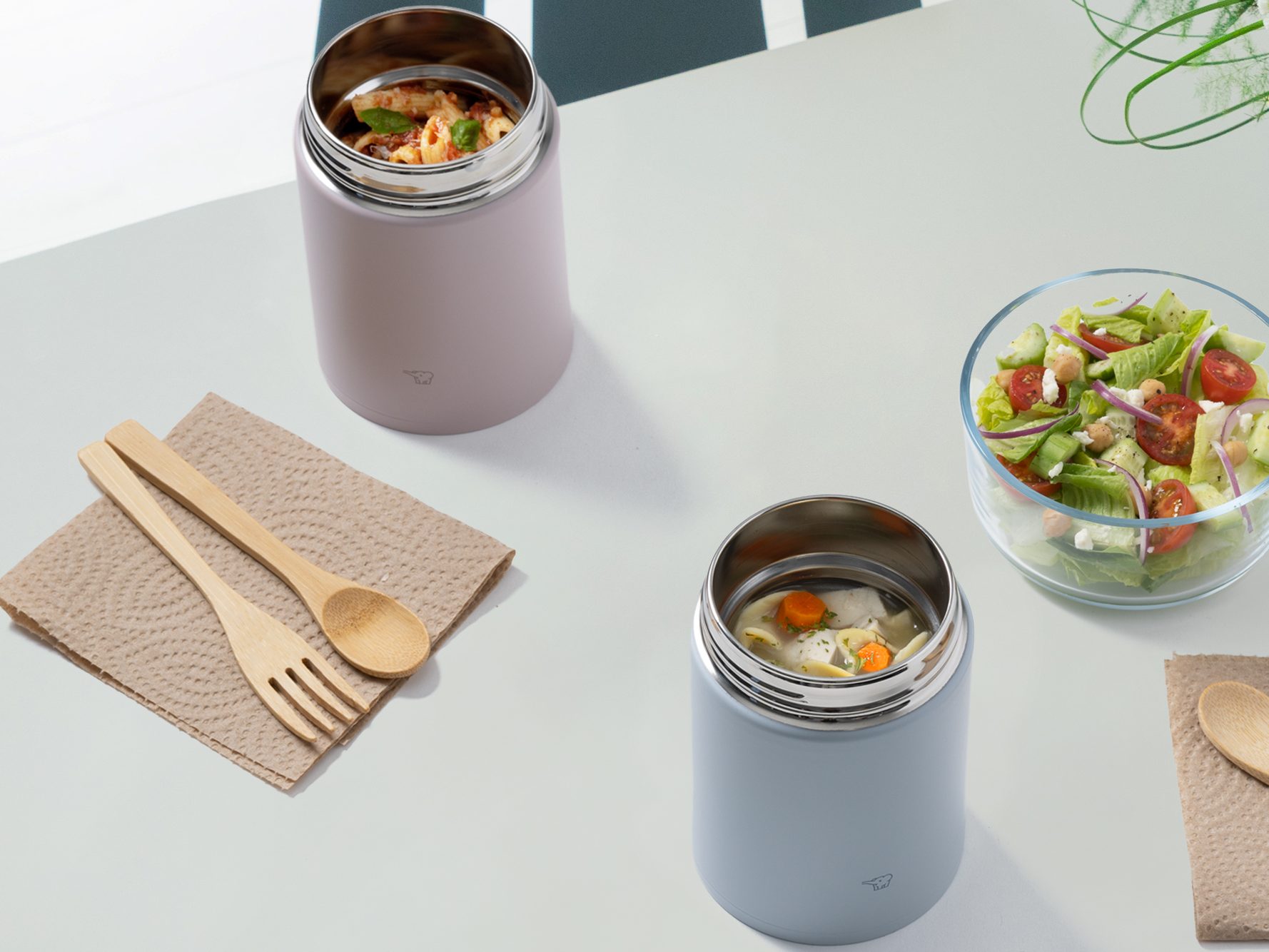 salad inside of the pink and blue food jar 