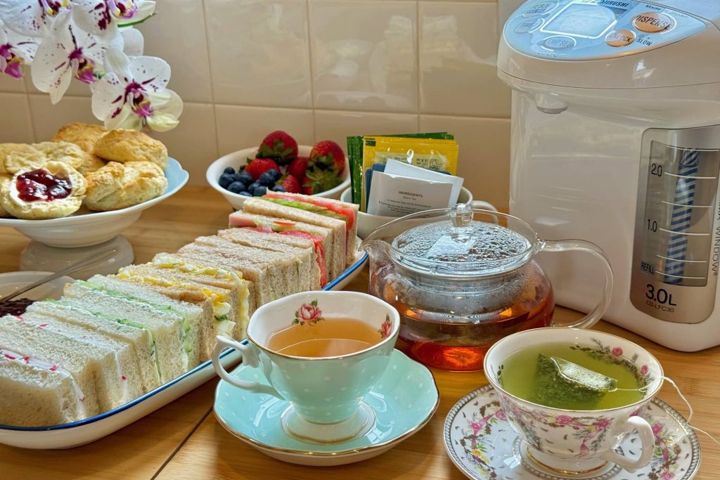 Afternoon tea with sandwiches, scones and tea