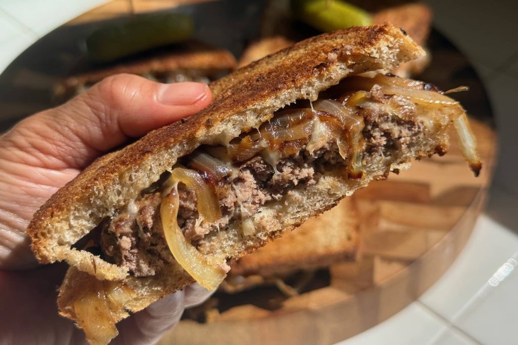 close-up of patty melt sandwich shown from side