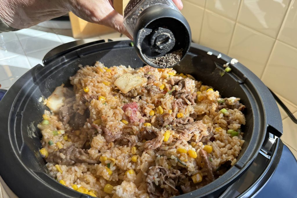 sprinkling pepper into the Pepper Rice