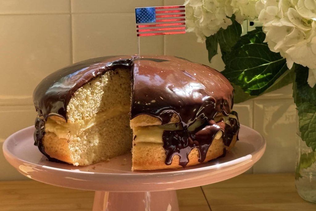 Boston Cream Pie on pedestal with American flag on top
