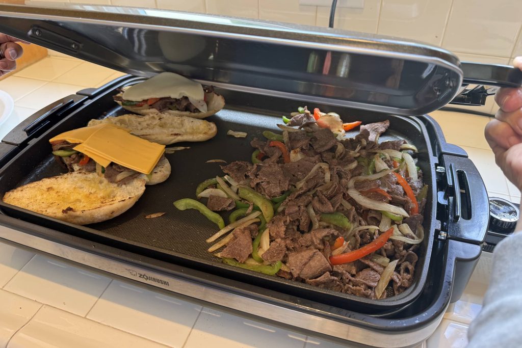 Using cover on electric griddle to melt cheese faster